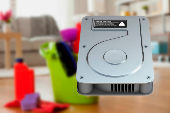 Warum visualisiert Apple die interne SSD eigentich immer noch als Festplatte? Bild einer stilisierten Festplatte mit Putzmitteln im Hintergrund
