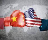 Symbolbild zeigt gegnerische Box-Handschuhe mit China- und US-Flagge